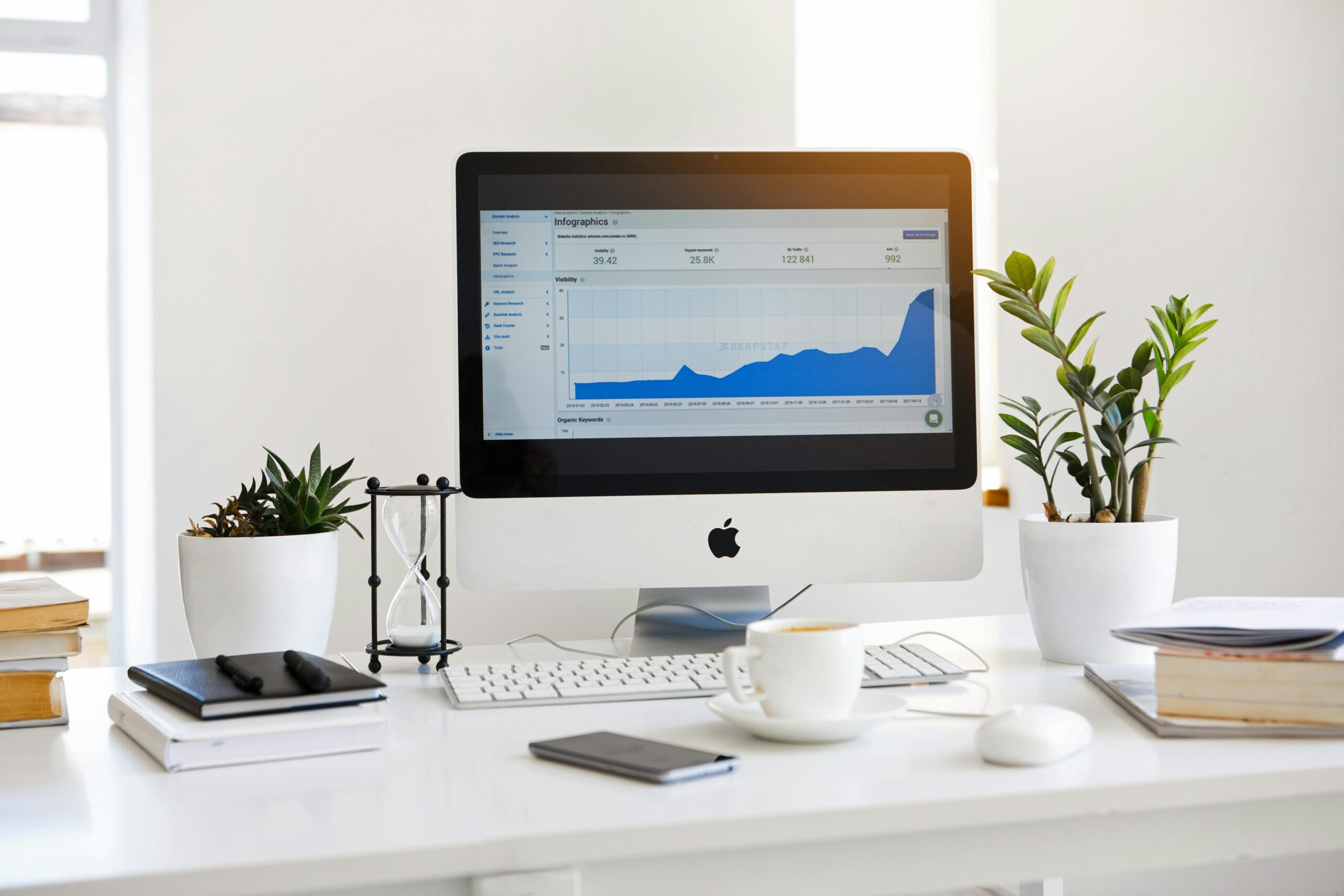 Erfolgreich im Vollzeit-Heimarbeit: Tipps und Strategien 2 Silberner Imac Mit Liniendiagramm Auf Dem Schreibtisch